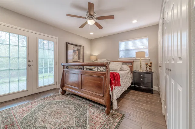 a bedroom with a bed a dresser next to a window
