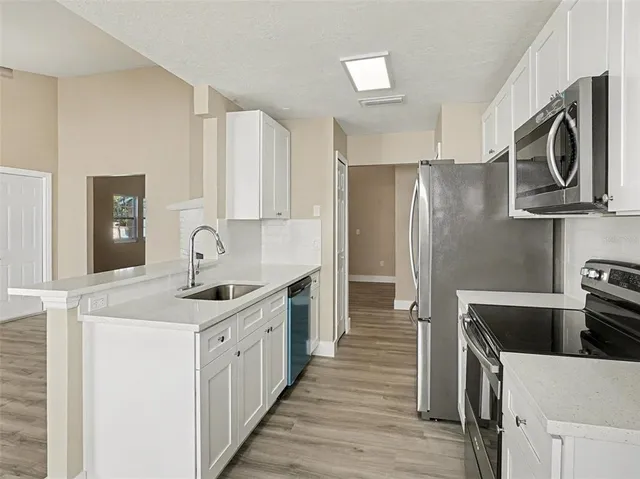 wooden floor in an empty room with a fireplace