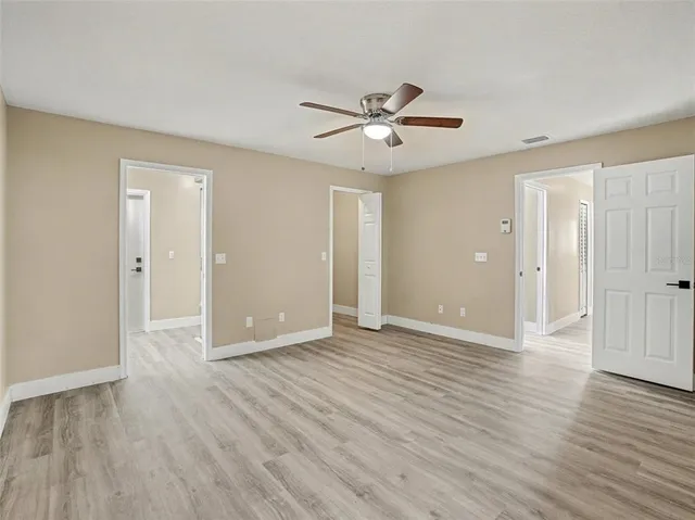 a view of an empty room and wooden floor