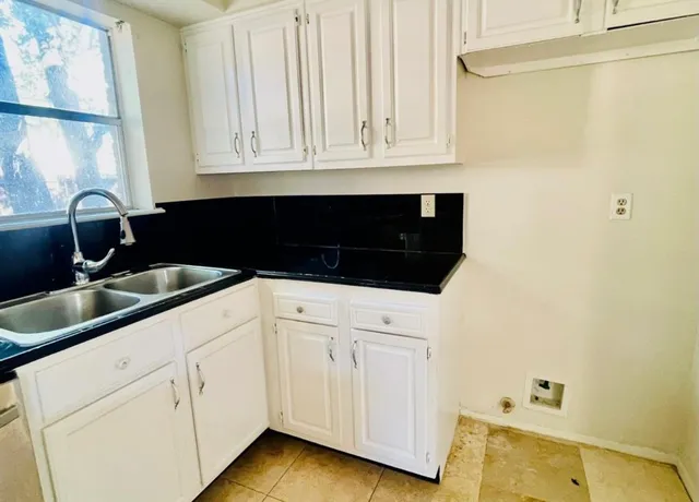 a kitchen with a sink and cabinets