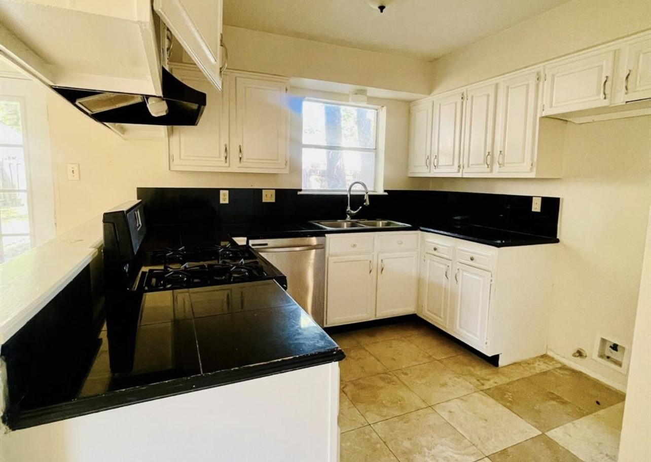 24022 Spring Fork Drive Spring, TX 77373 - Photo 20 of 23 a kitchen with stainless steel appliances a sink a stove and a refrigerator