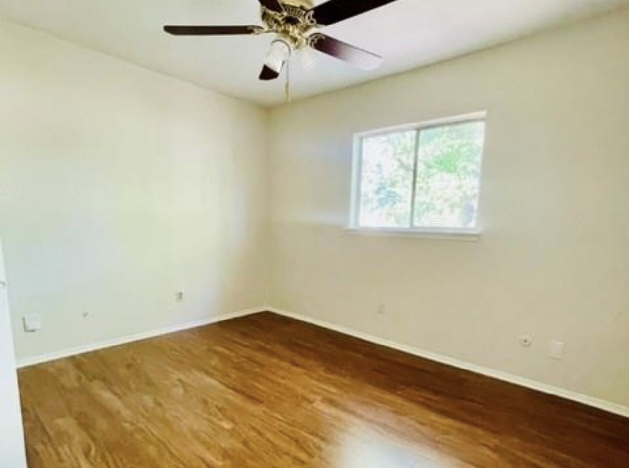 24022 Spring Fork Drive Spring, TX 77373 - Photo 23 of 23 en empty room with wooden floor and windows