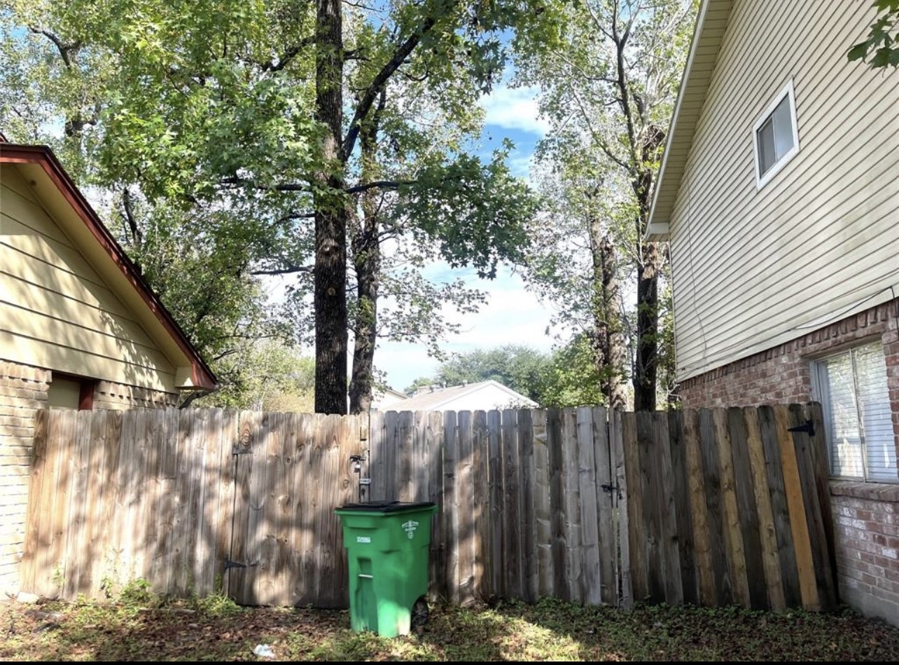 24022 Spring Fork Drive Spring, TX 77373 - Photo 6 of 23 a view of a wooden fence next to a large tree