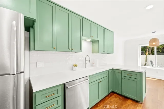 a kitchen with stainless steel appliances a stove sink and cabinets