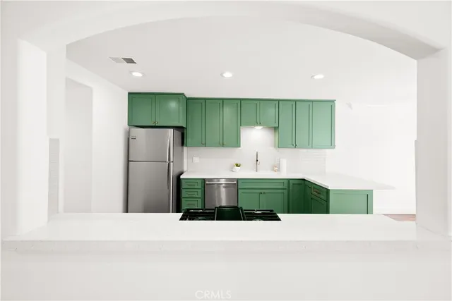 a view of a livingroom with a chandelier fan and windows