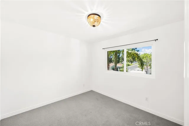 a bedroom with a bed and a potted plant