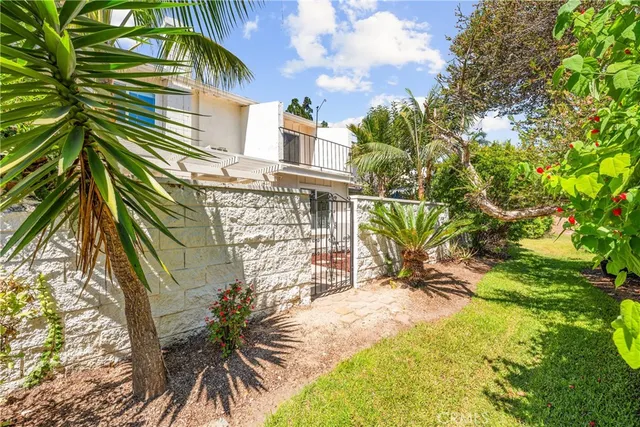 a view of a house with a yard and sitting area