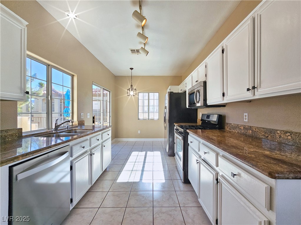 1851 Hillpointe Road, Unit 2124 Henderson, NV 89074 - Photo 8 of 24 Kitchen featuring light tile patterned flooring, a sink, visible vents, white cabinetry, and stainless steel appliances