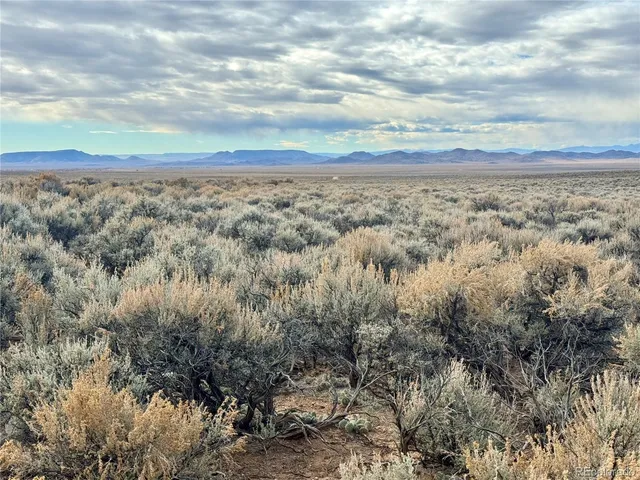 a view of an ocean beach and mountain
