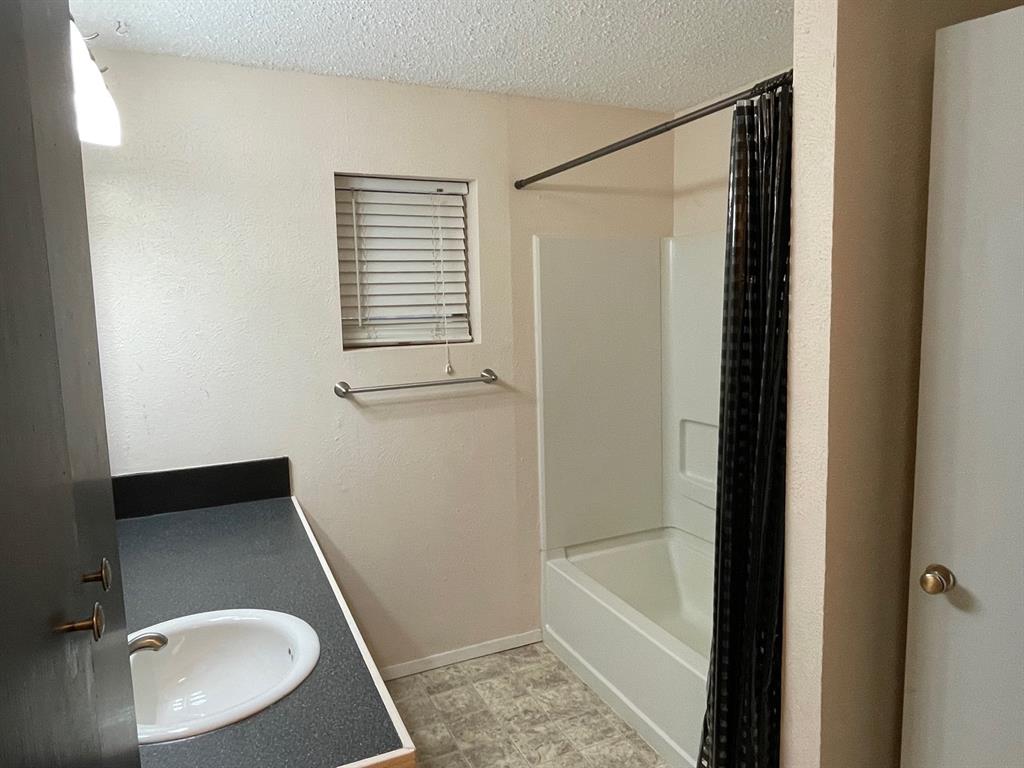 11888 Fm Road Seymour, TX 76380 - Photo 12 of 14 a bathroom with a sink and a mirror