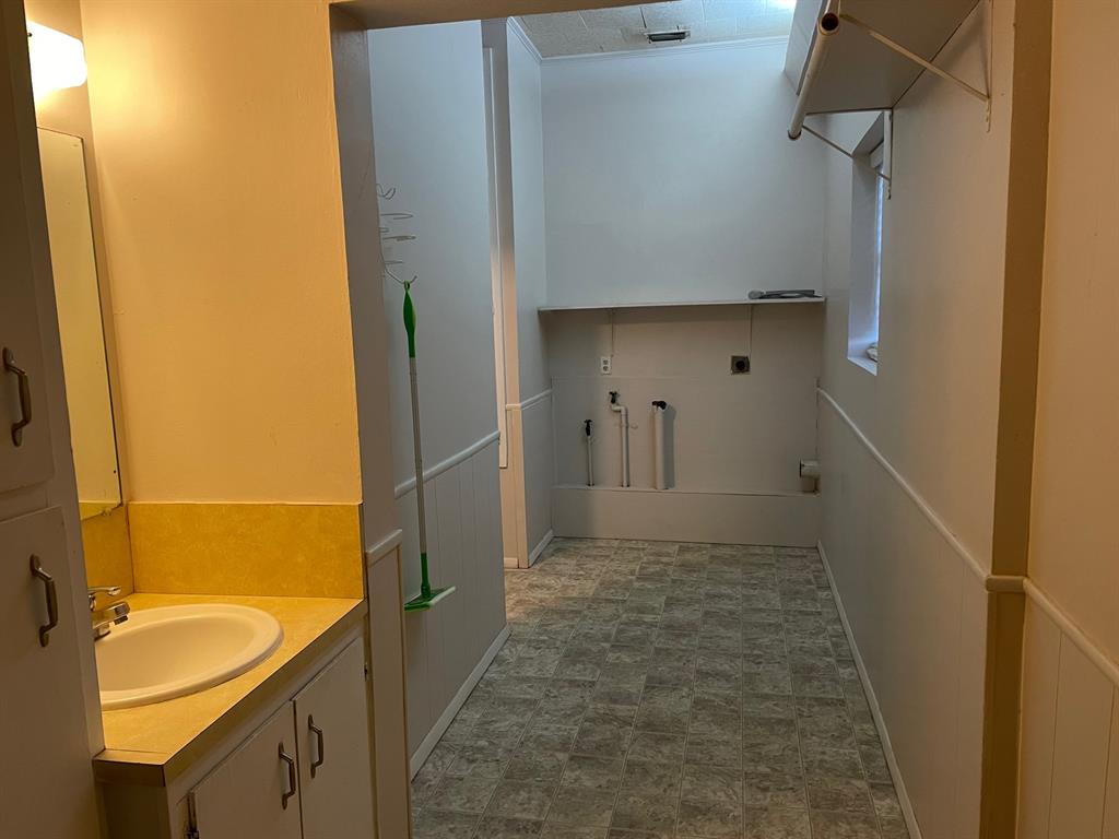 11888 Fm Road Seymour, TX 76380 - Photo 13 of 14 a bathroom with a granite countertop sink and a mirror