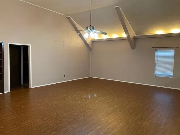 a view of a room with wooden floor
