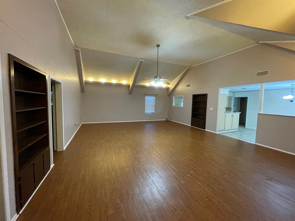 11888 Fm Road Seymour, TX 76380 - Photo 3 of 14 a view of a room with wooden floor and a ceiling fan