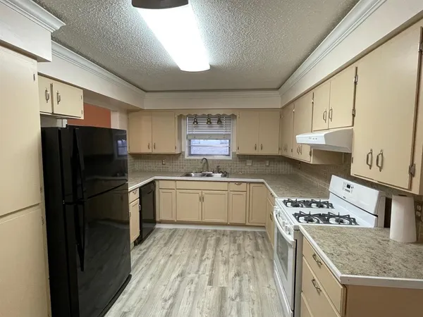 a kitchen with a refrigerator and a sink