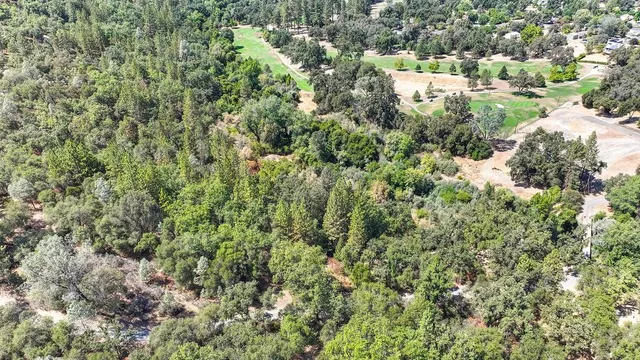 an aerial view of a houses with a yard
