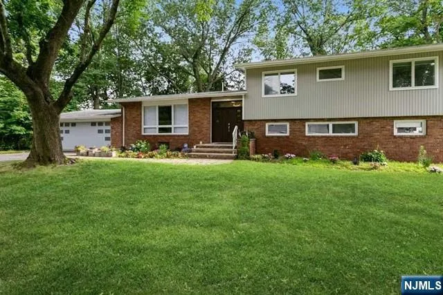 a front view of house with yard and outdoor seating
