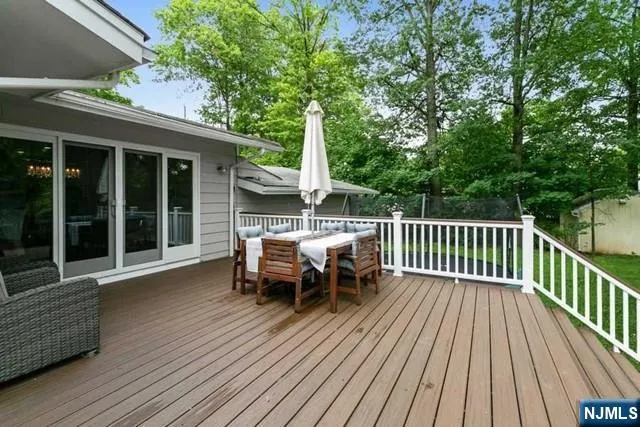 a view of a chairs and table on the wooden deck