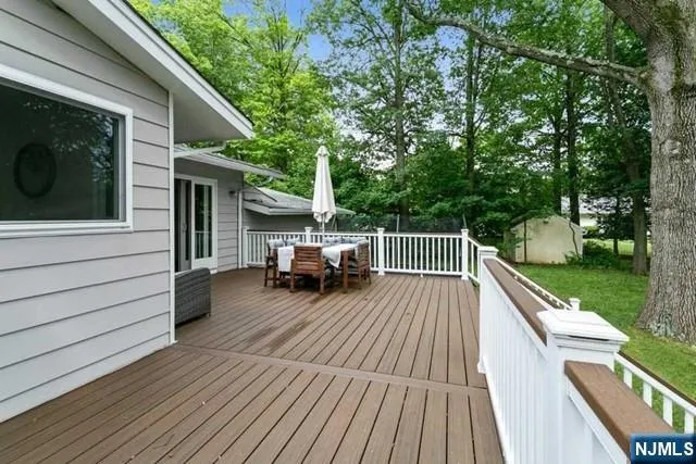 a view of house with deck outdoor seating and barbeque oven