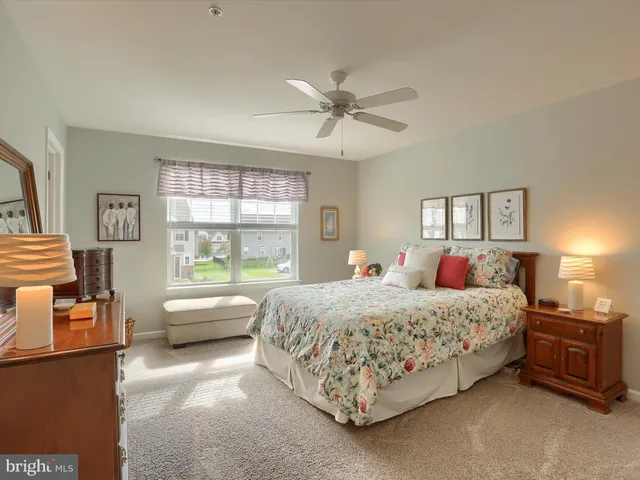 a bedroom with a bed couch and window