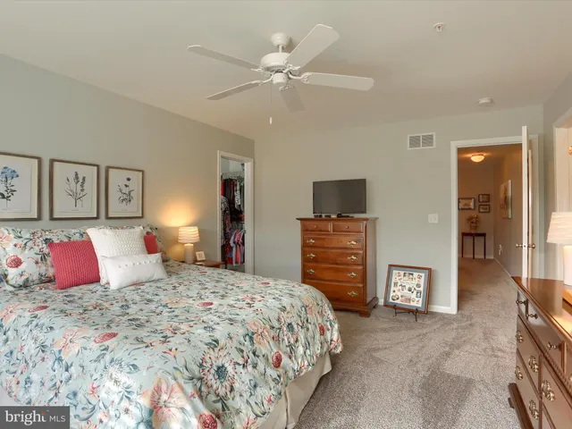 a bedroom with a large bed and a chandelier