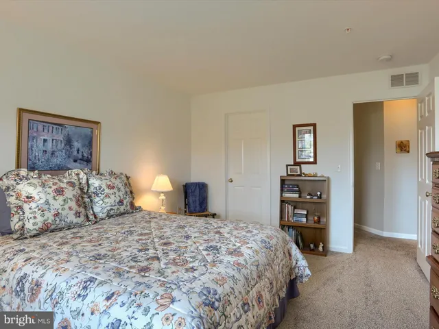 a bedroom with a bed and a night stand