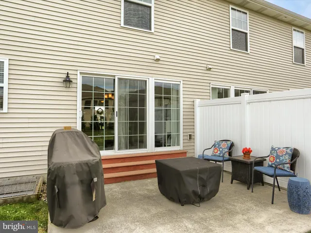 a view of a big house with a big yard and potted plants