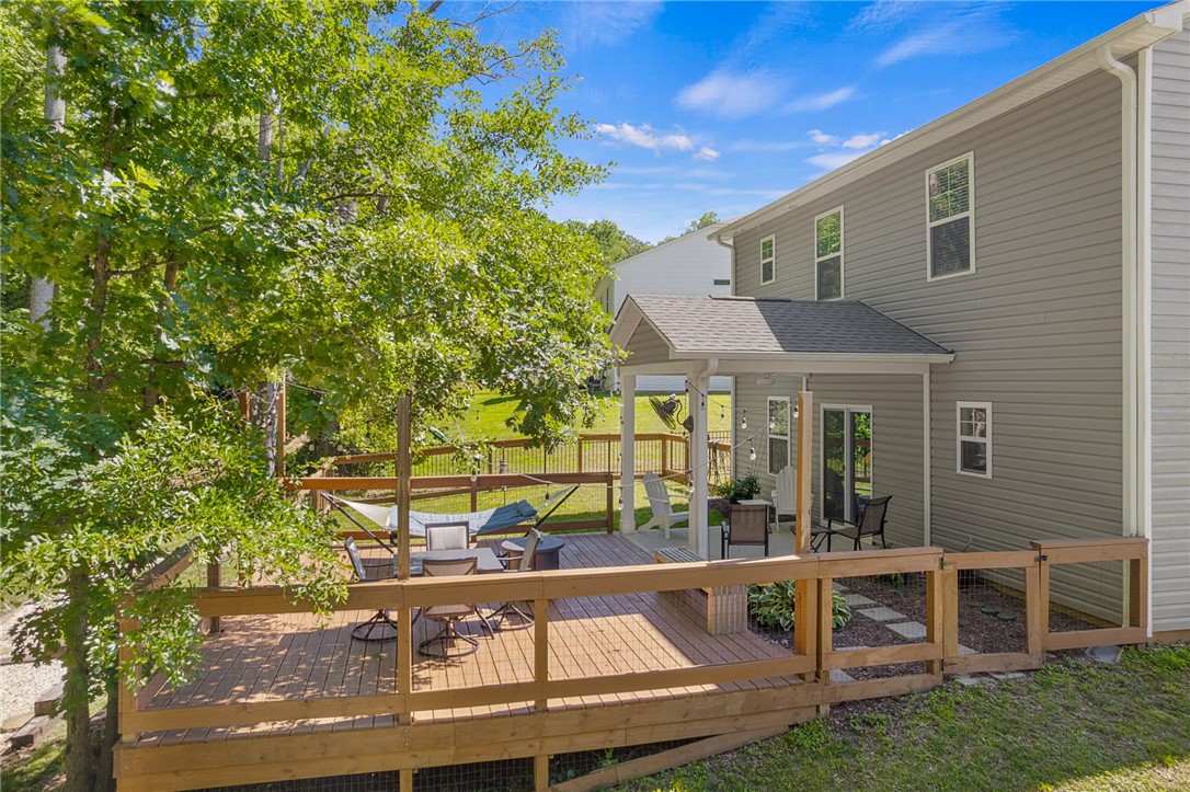 430 Johnson Road Central, SC 29630 - Photo 25 of 36 A spacious wooden deck extends from the residence, providing ample outdoor living and entertaining areas amidst verdant trees.