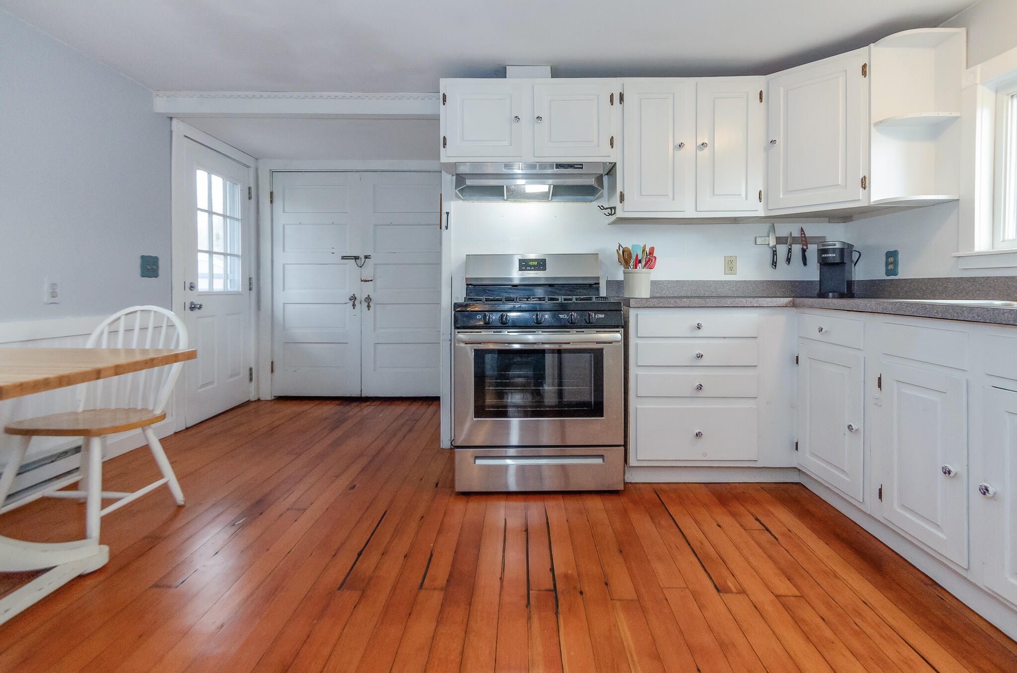 9 Mansion Street West Harwich, MA 02671 - Photo 11 of 26 a kitchen with granite countertop wooden floors and stainless steel appliances