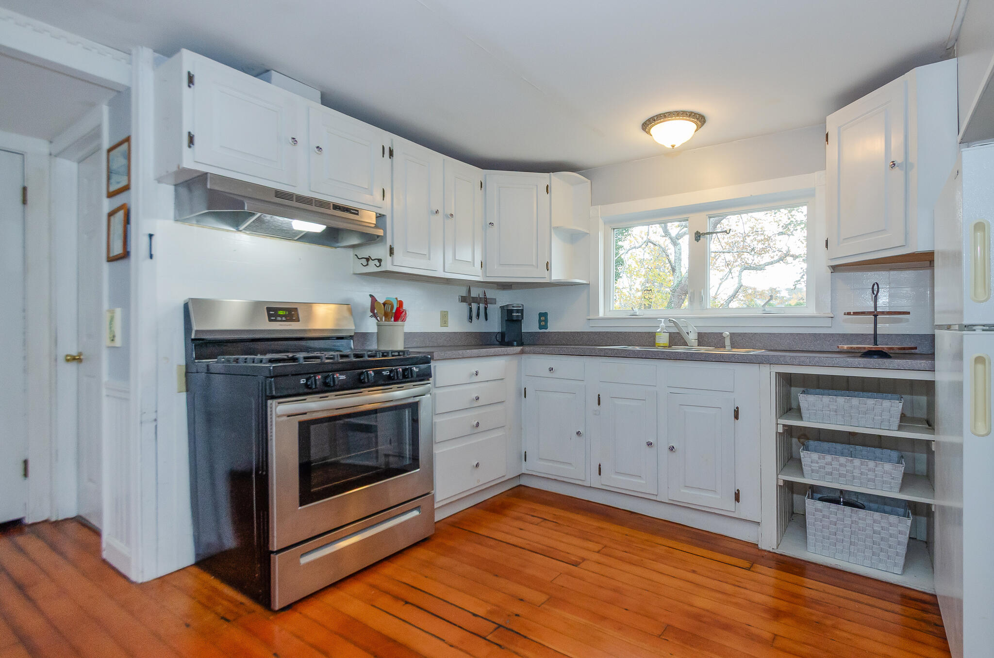 9 Mansion Street West Harwich, MA 02671 - Photo 12 of 26 a kitchen with cabinets stainless steel appliances and a window