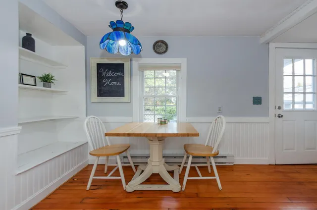 a dining room with furniture and window