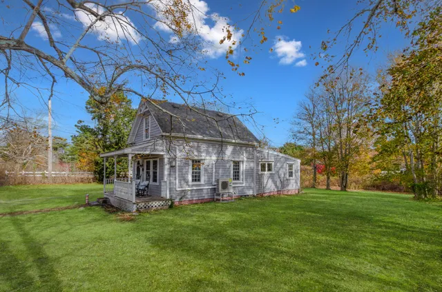 a view of a house with a yard porch and sitting area
