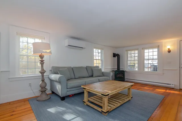 a living room with furniture rug and window