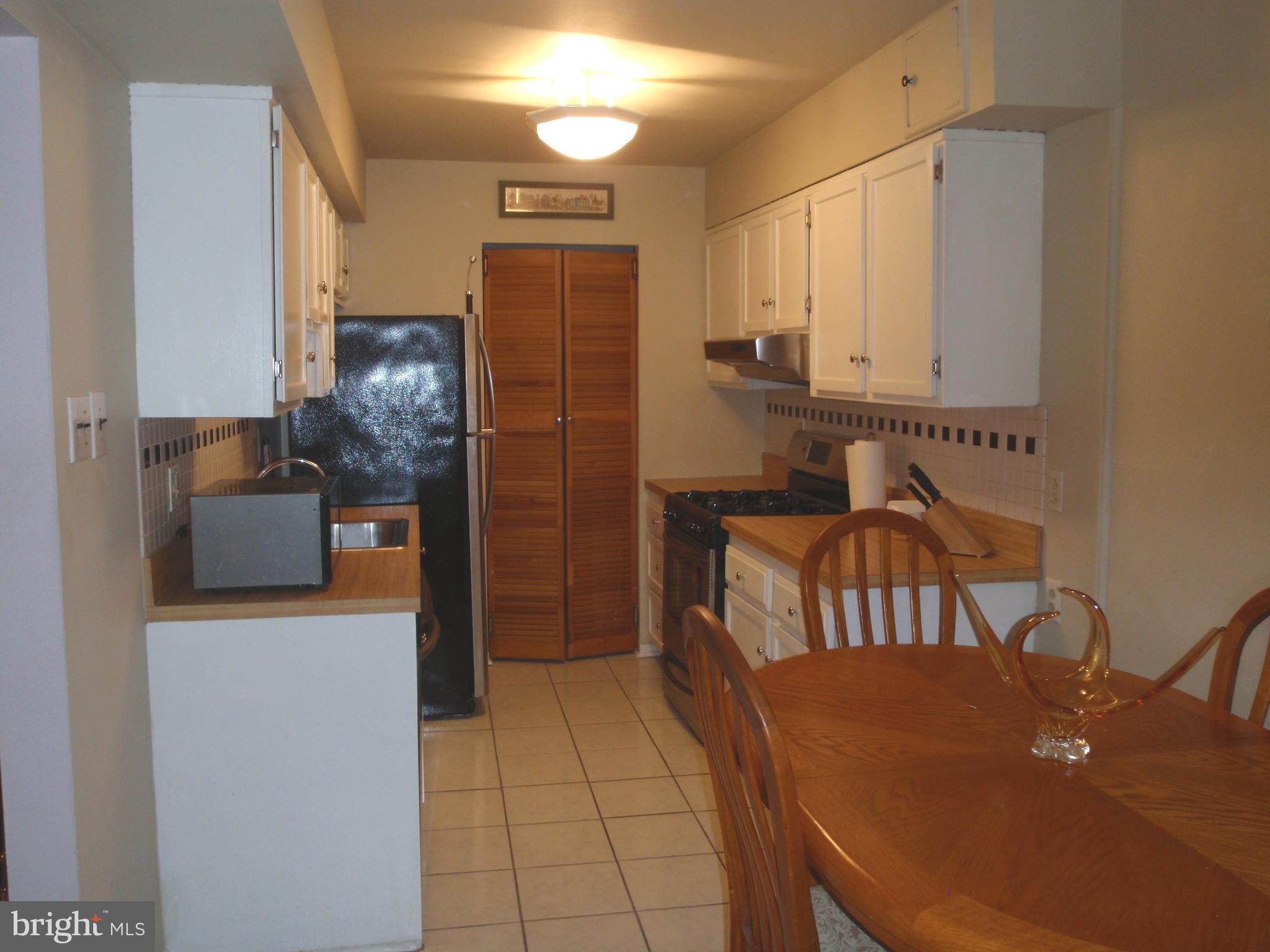 7015 Ridge Avenue, Unit 15 Philadelphia, PA 19128 - Photo 12 of 28 Kitchen with white cabinetry, ceramic tiled floor