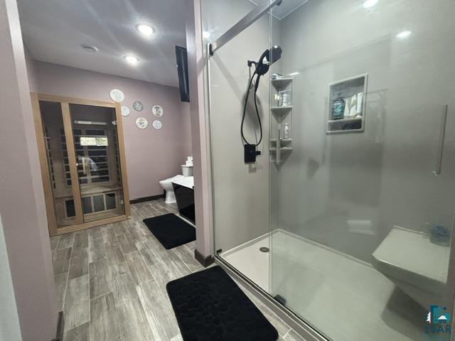 3454 Anderson Road Hibbing, MN 55746 - Photo 9 of 31 Modern bathroom featuring a spacious walk-in shower with a built-in bench and recessed shelving