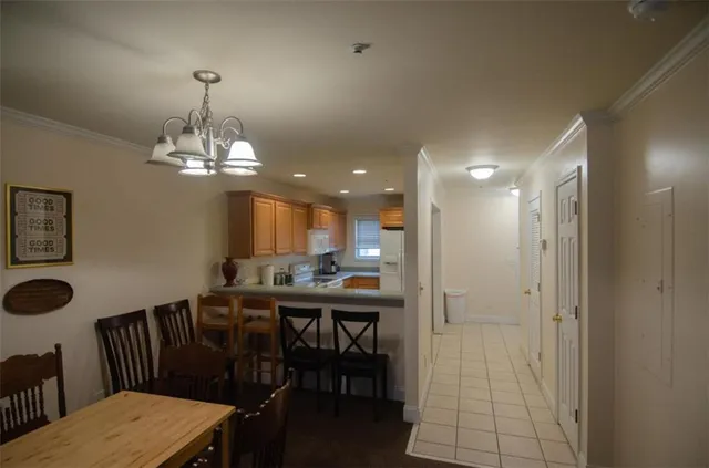 a view of a dining room with furniture and chandelier