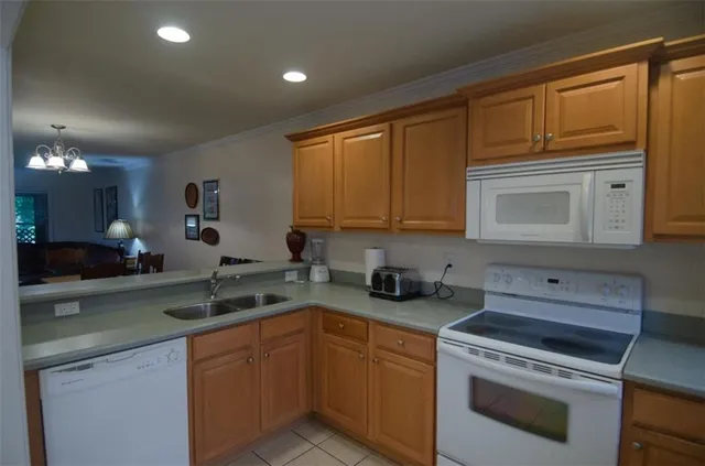 a kitchen with a sink stove and microwave