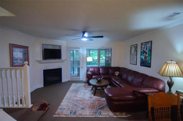 a living room with furniture a fireplace and a flat screen tv