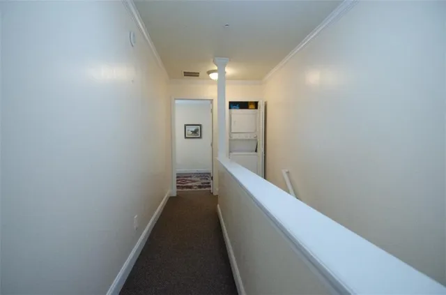 a view of hallway with wooden floor