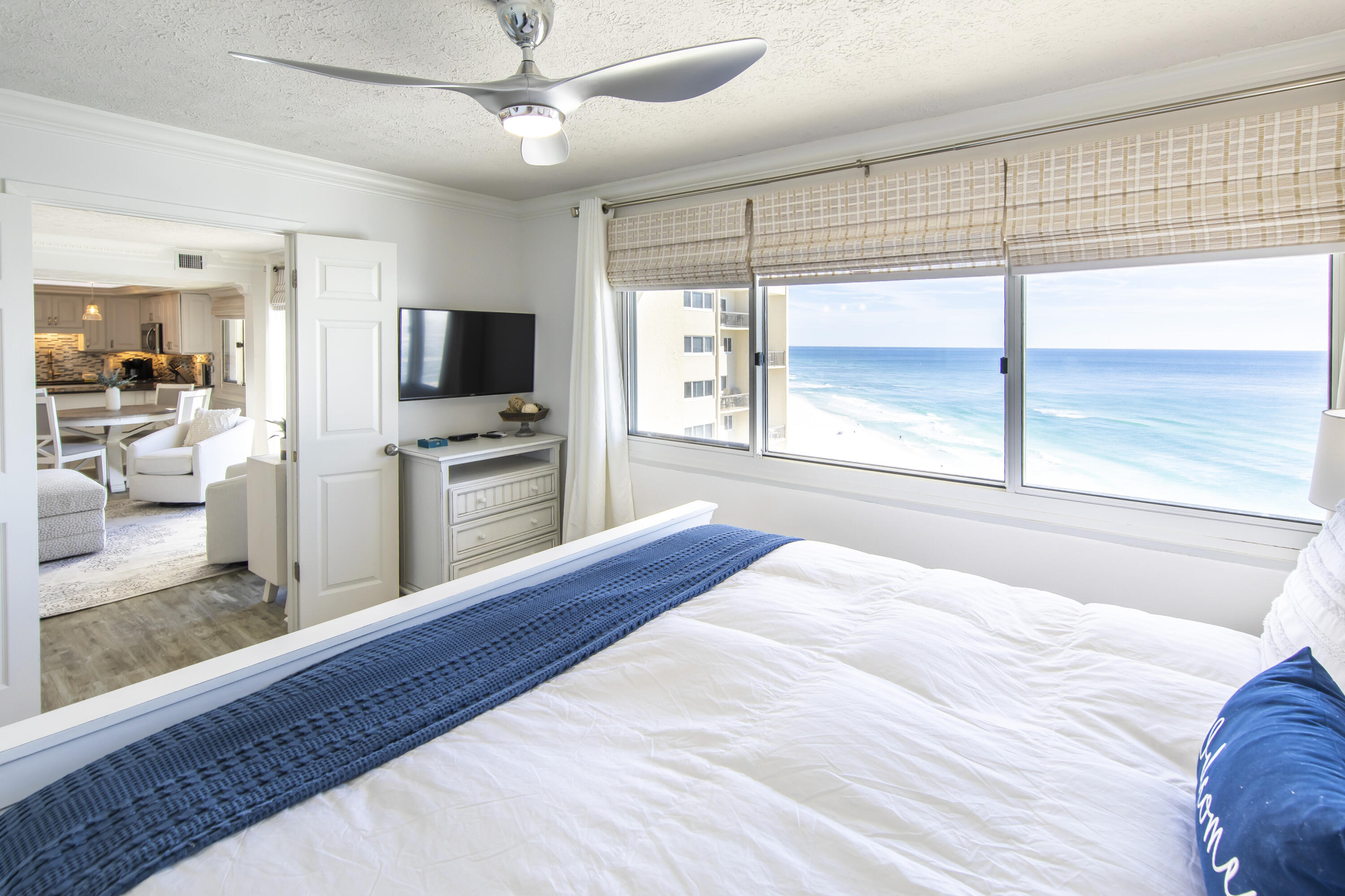 23223 Front Beach Road, Unit A122 Panama City Beach, FL 32413 - Photo 16 of 45 a bedroom with a bed and a flat screen tv