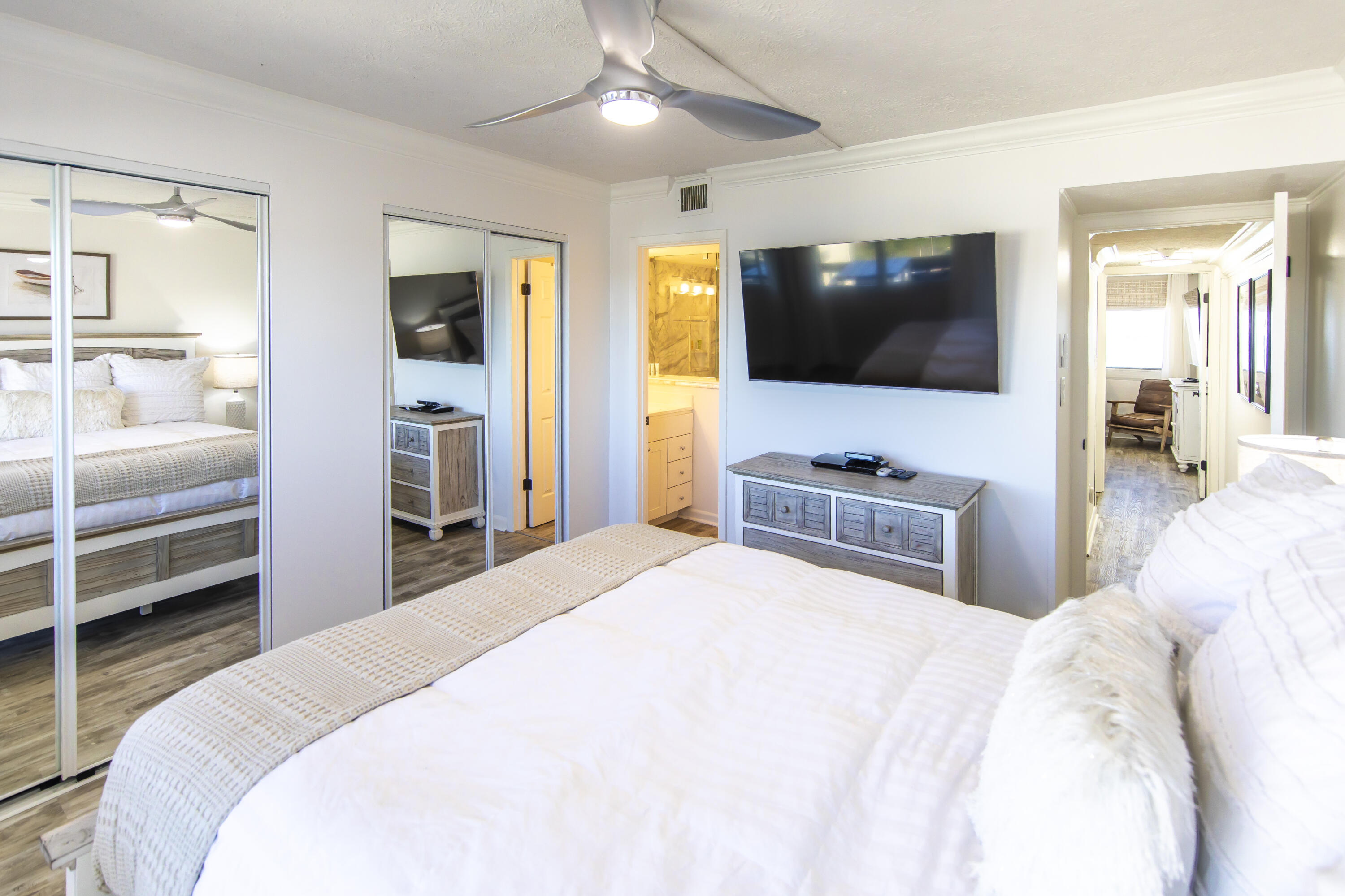 23223 Front Beach Road, Unit A122 Panama City Beach, FL 32413 - Photo 22 of 45 a bedroom with a bed and a flat screen tv