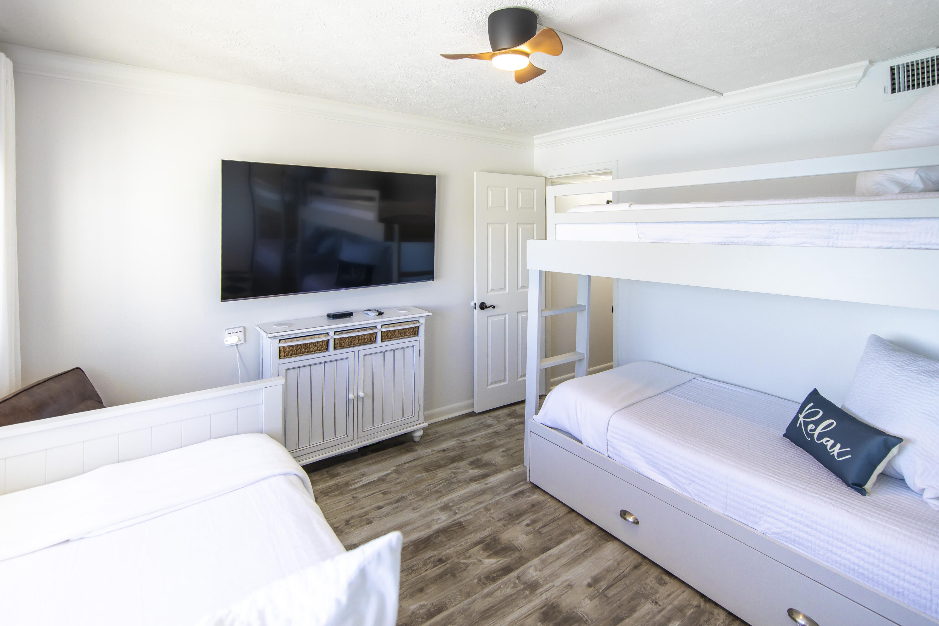 23223 Front Beach Road, Unit A122 Panama City Beach, FL 32413 - Photo 29 of 45 a bedroom with a bed and a flat screen tv