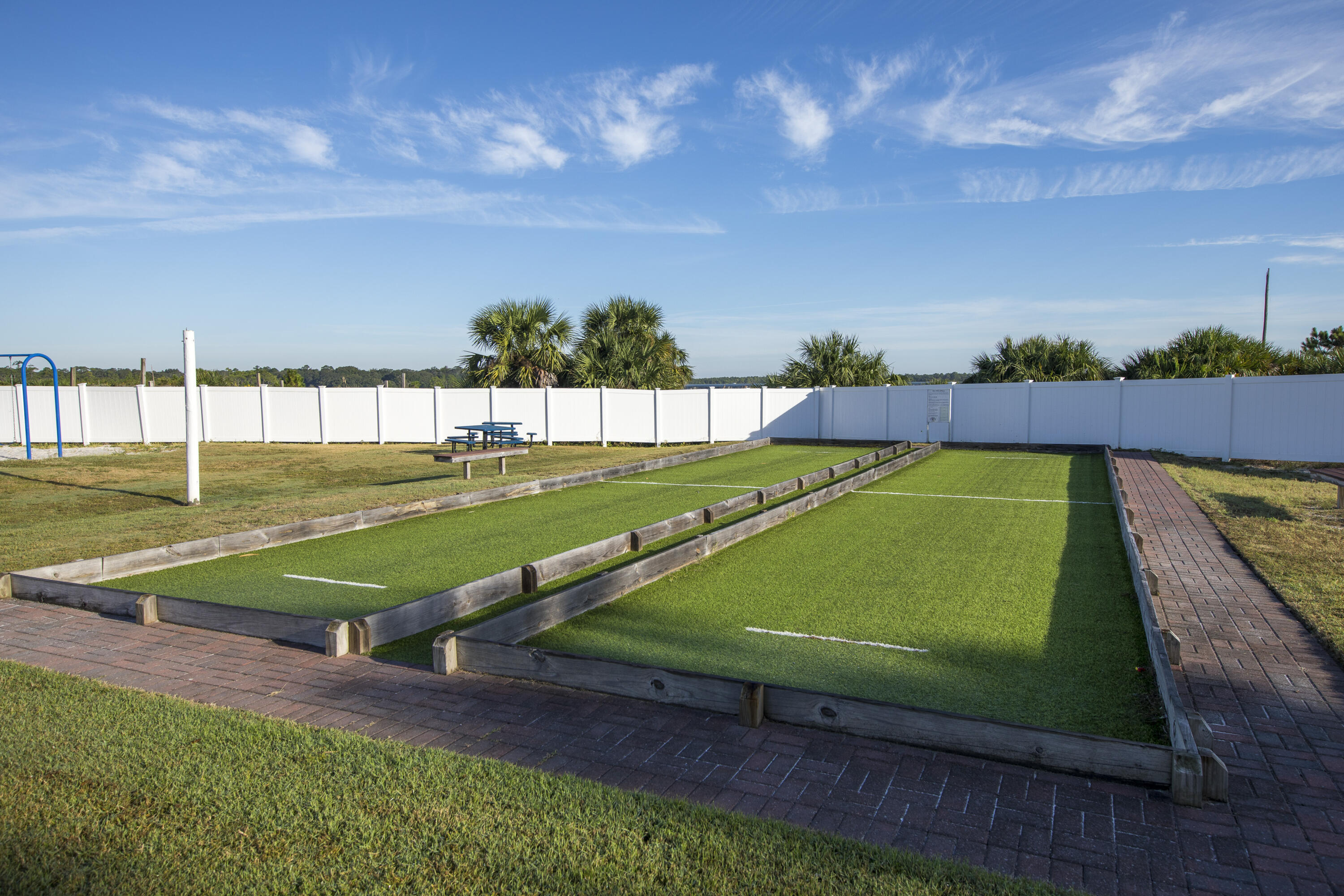 23223 Front Beach Road, Unit A122 Panama City Beach, FL 32413 - Photo 42 of 45 a view of a tennis ground with large trees