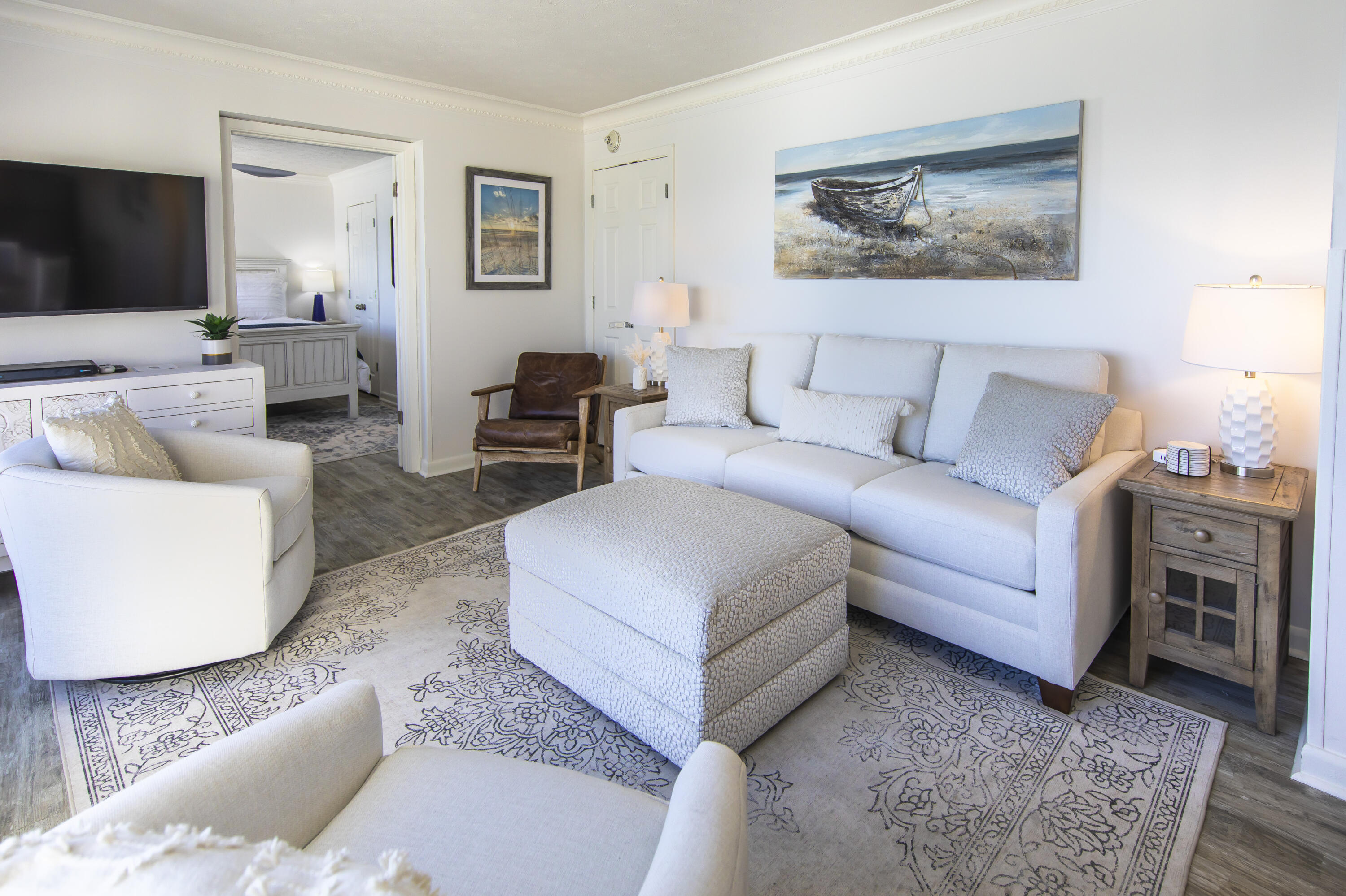 23223 Front Beach Road, Unit A122 Panama City Beach, FL 32413 - Photo 5 of 45 a living room with furniture and a flat screen tv