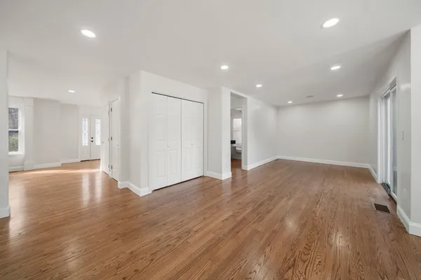 a view of an empty room with wooden floor