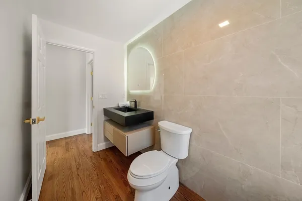 a white toilet sitting next to a bathroom sink