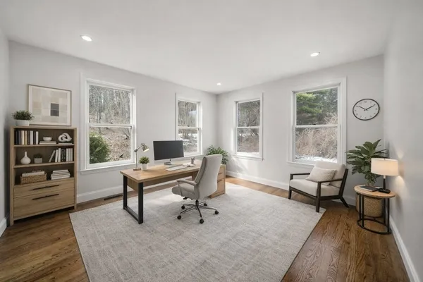 a living room with furniture a table and a large window