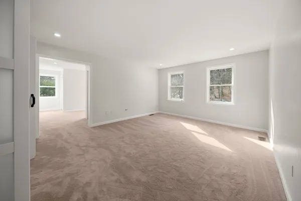 an empty room with windows and closet