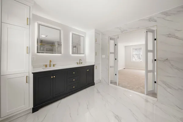 a spacious bathroom with a shower sink double and mirror