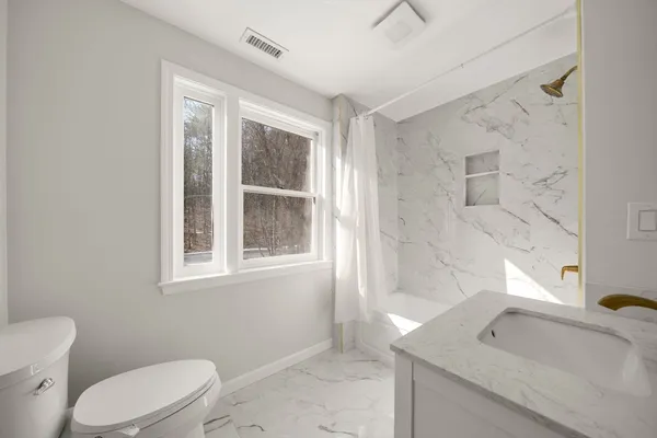 a bathroom with a sink a toilet and tub