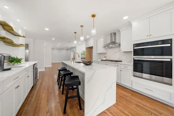 a kitchen with a sink stainless steel appliances and cabinets